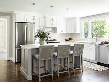 Westwood kitchen with white cabinets stainless steel appliances serena and lily stools. design by JP Hoffman Design Build