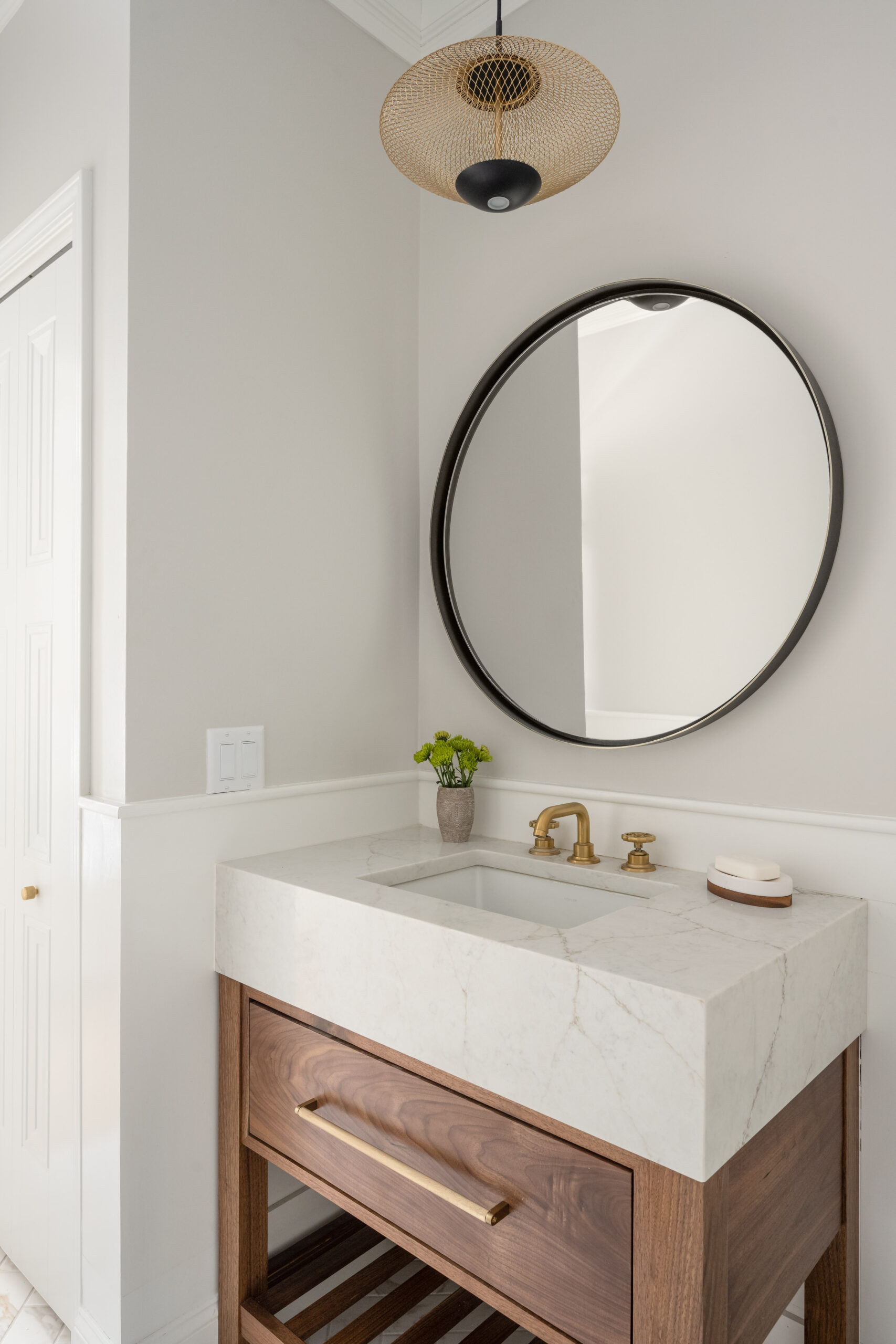 Needham powder room with white and gold floor tile and custom black walnut vanity and wall wainscoting. Design by JP Hoffman Design Build